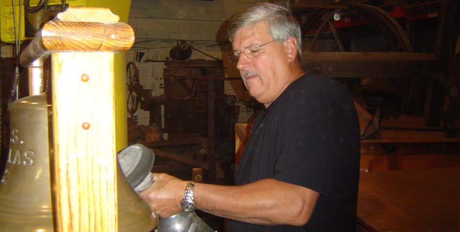 Bill Parker begins polishing Nicholas's ship's bell